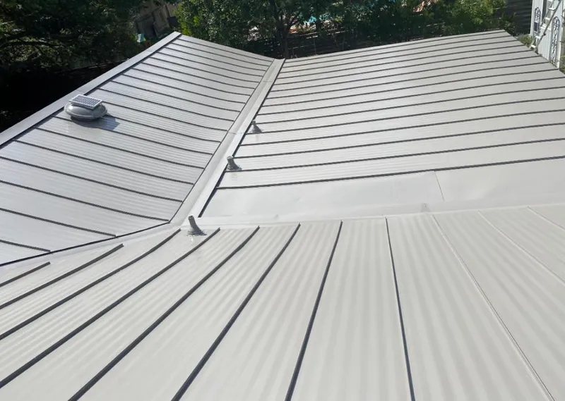 Solar attic fan installed on a metal roof for Roof Ventilation in Rusk